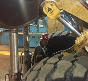 Underground maintenance mechanic checking bolt tension